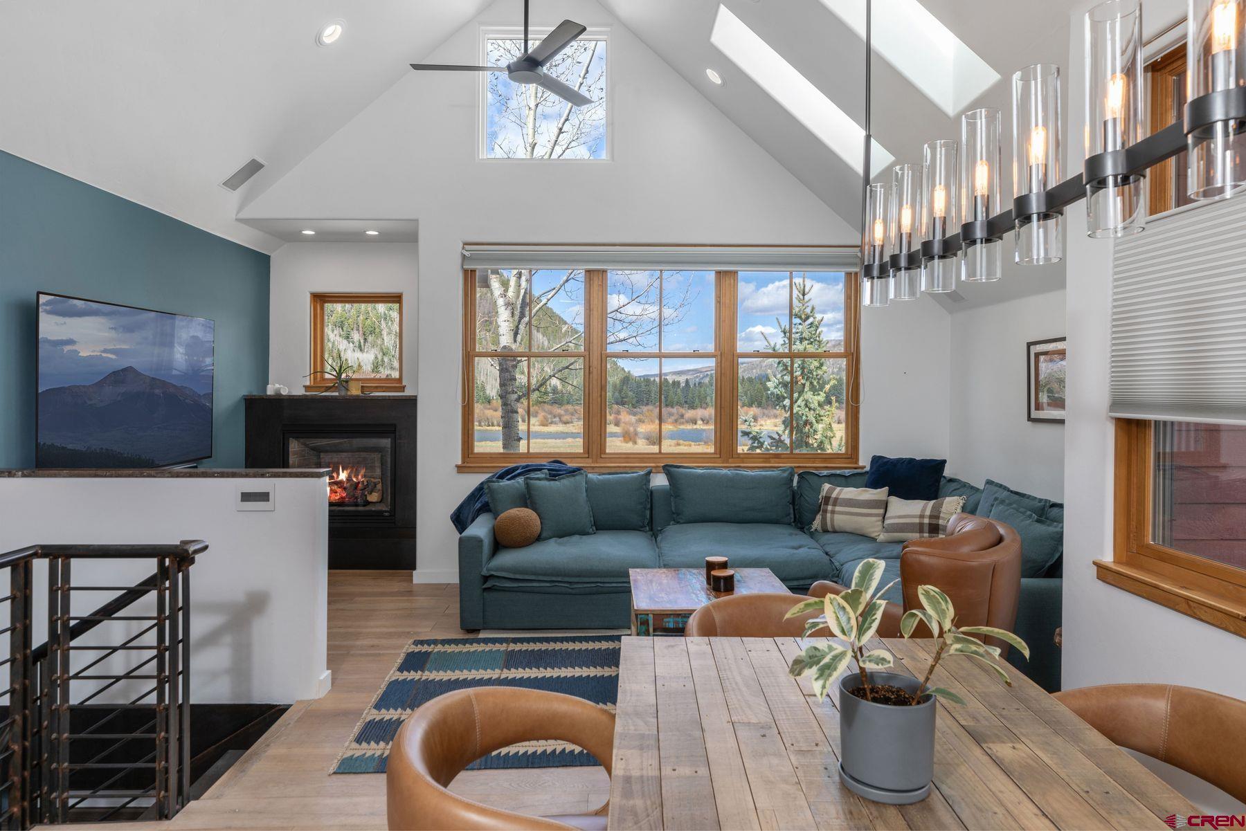 a living room with furniture a fireplace and a flat screen tv