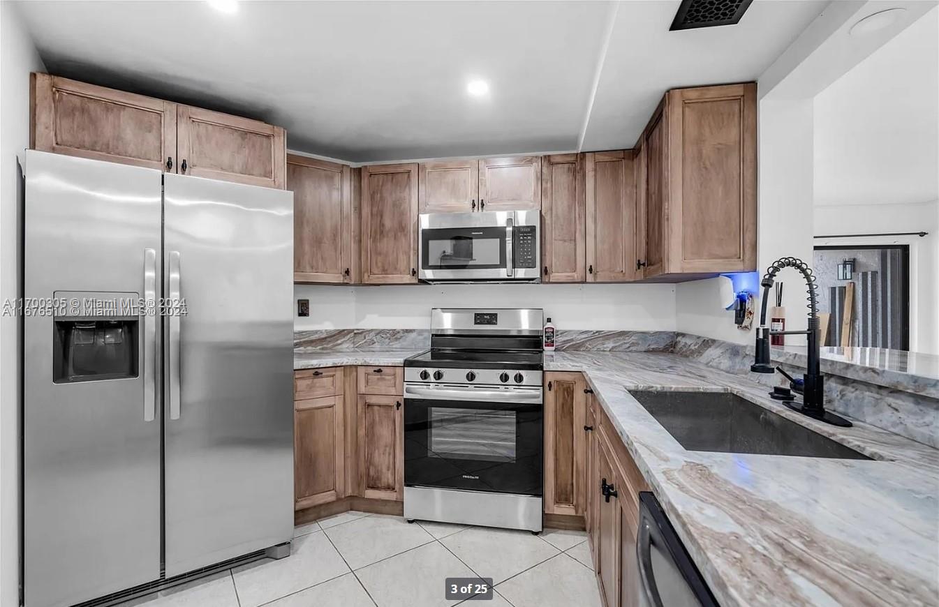 a kitchen with a sink stove and refrigerator