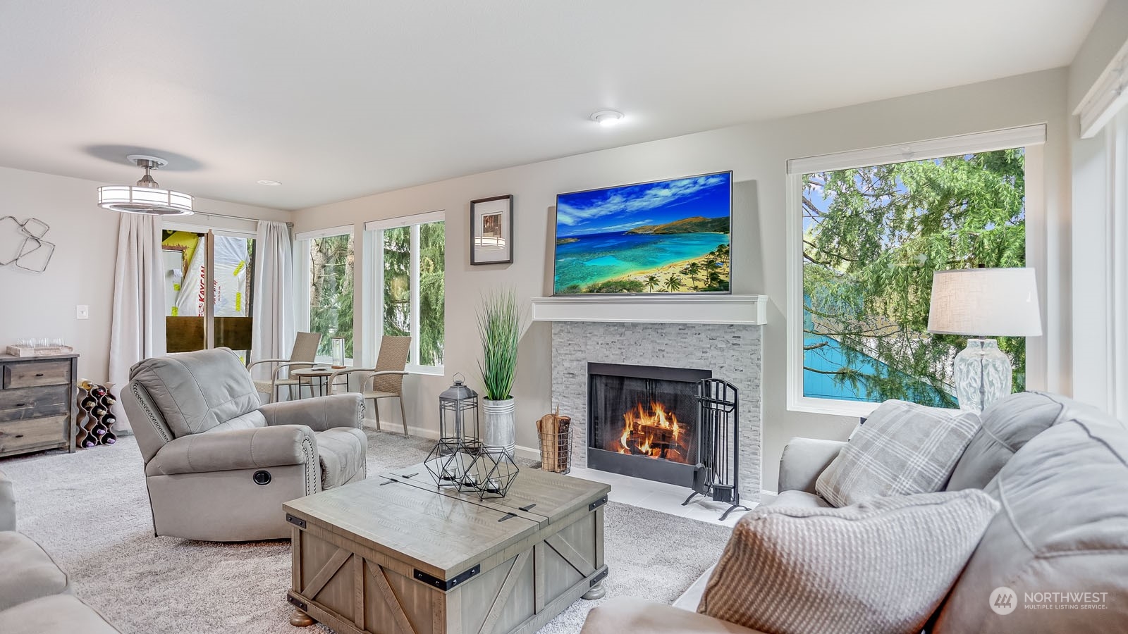 a living room with furniture a flat screen tv and a fireplace