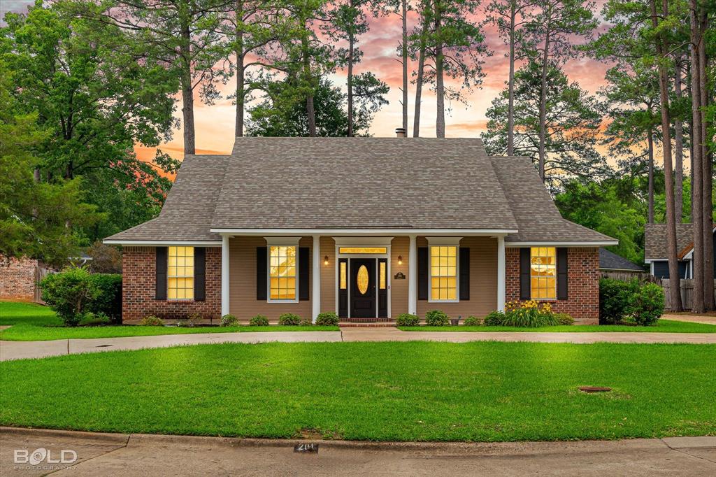 a front view of house with yard and green space