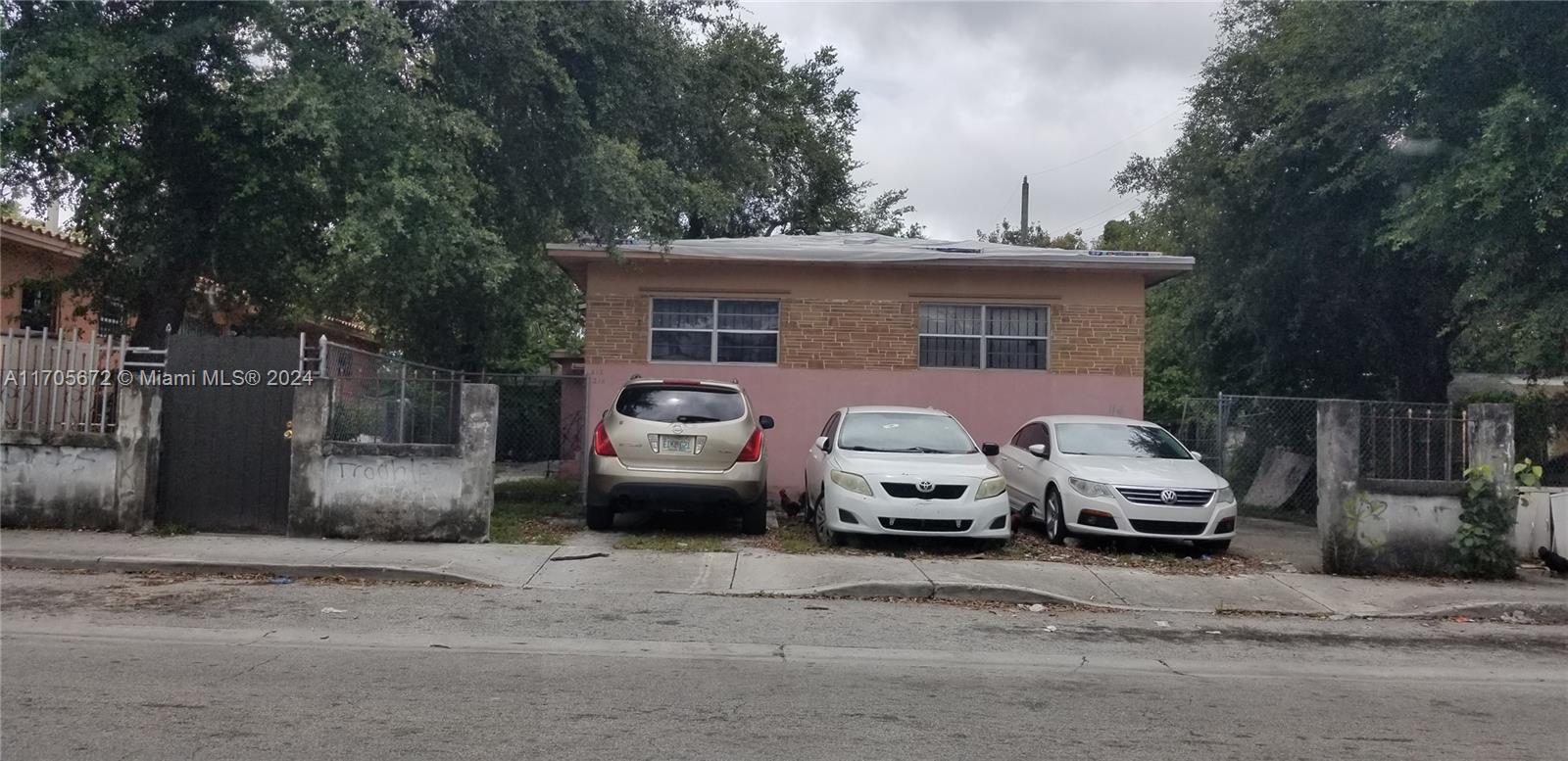 a couple of cars parked in front of a house