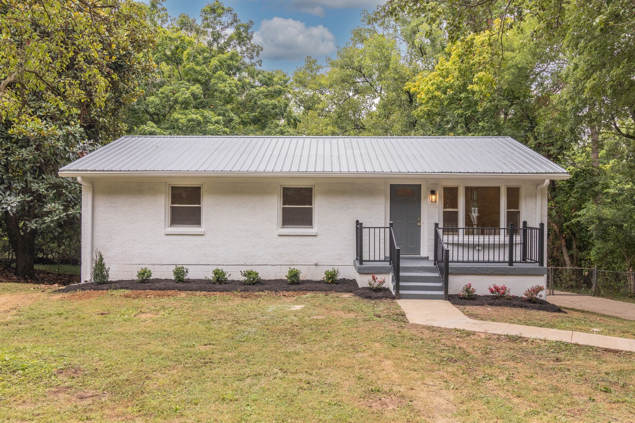 a front view of a house with a yard