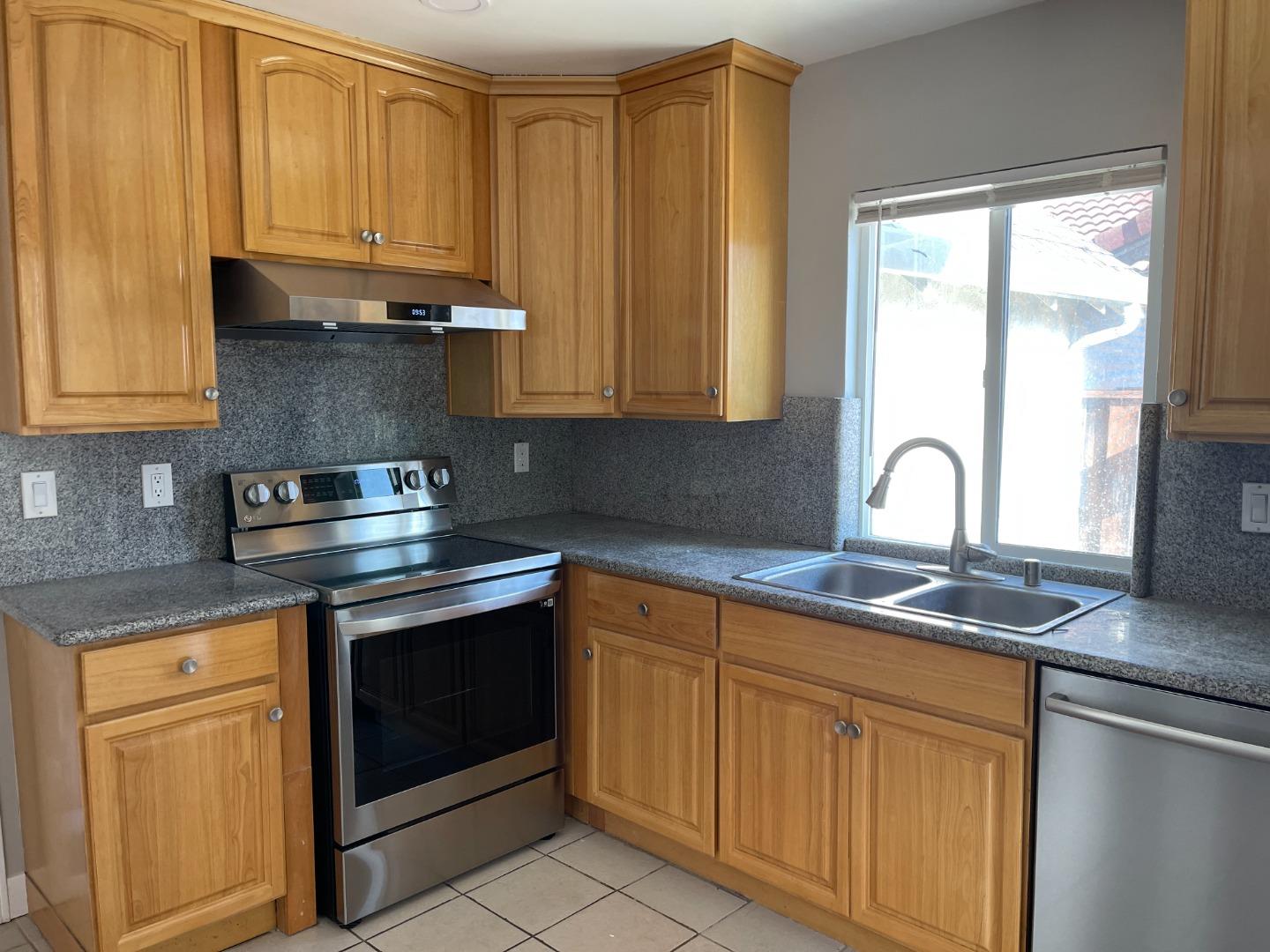 a kitchen with appliances cabinets and a sink