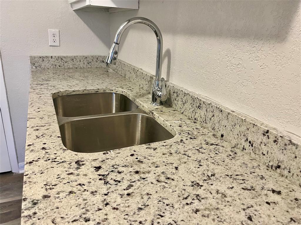 a close view of a sink a faucet and appliance in the kitchen