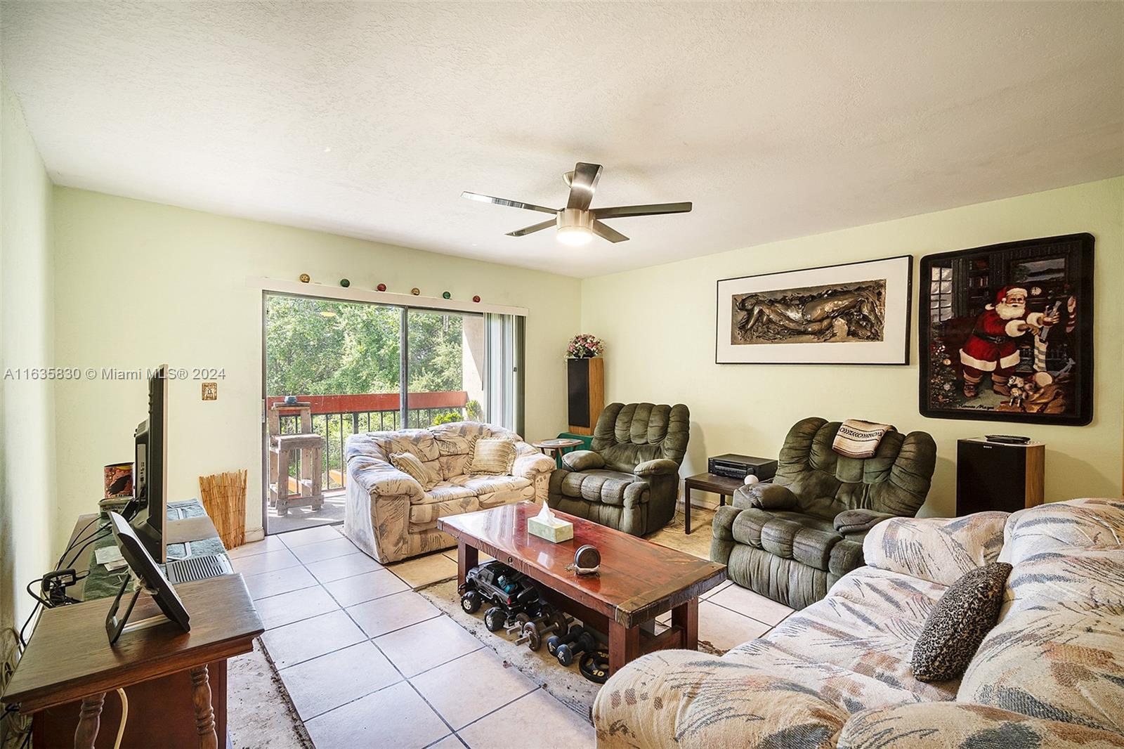 a living room with furniture a floor to ceiling window and a flat screen tv