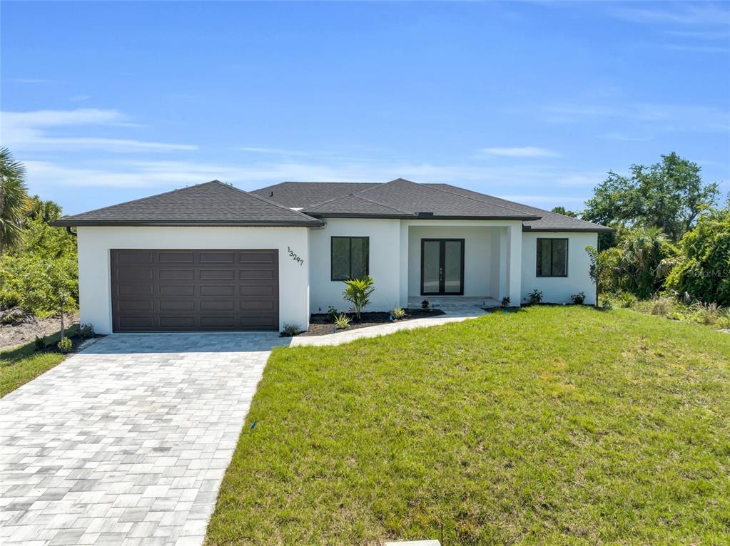 a front view of a house with a yard and garage