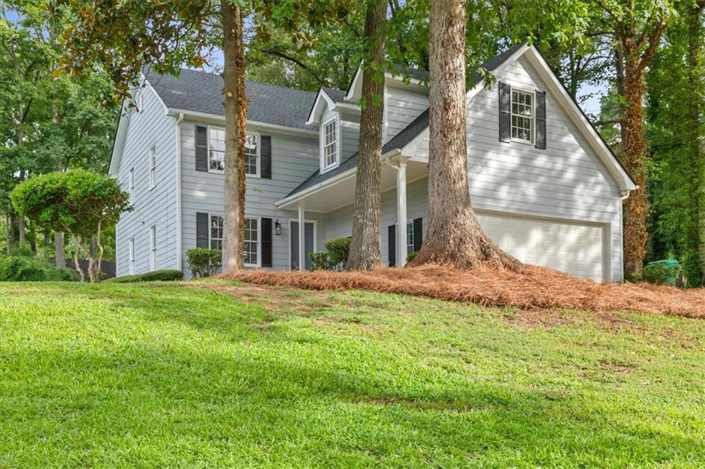 a front view of a house with a yard and garage