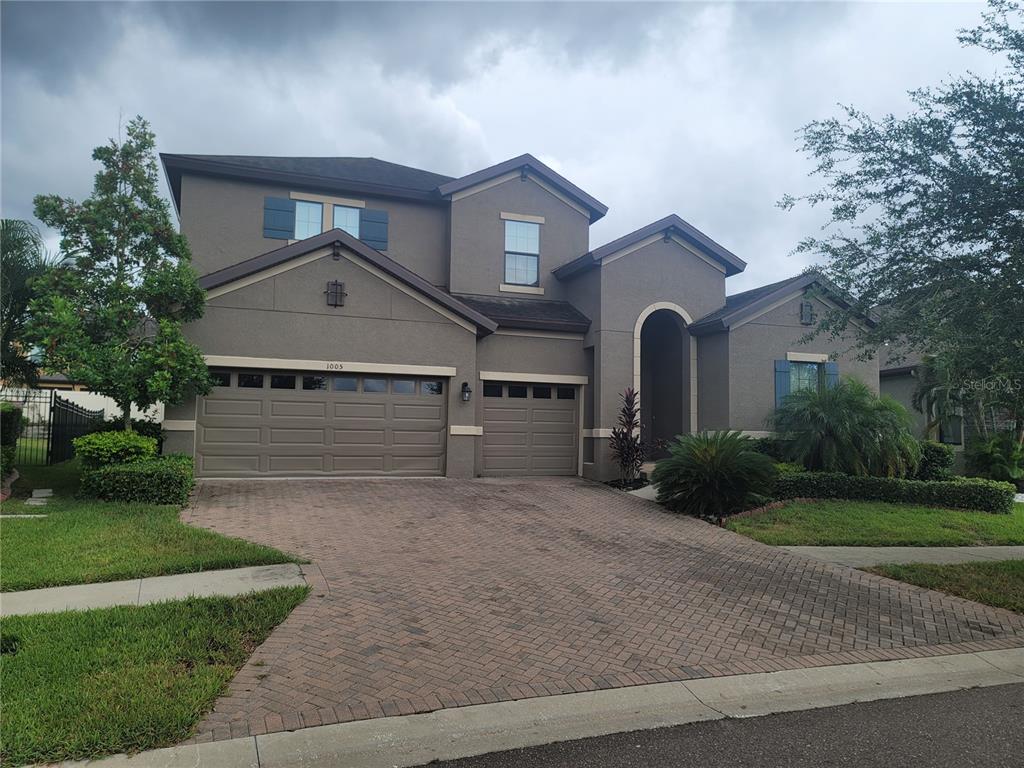 a front view of a house with a yard and garage