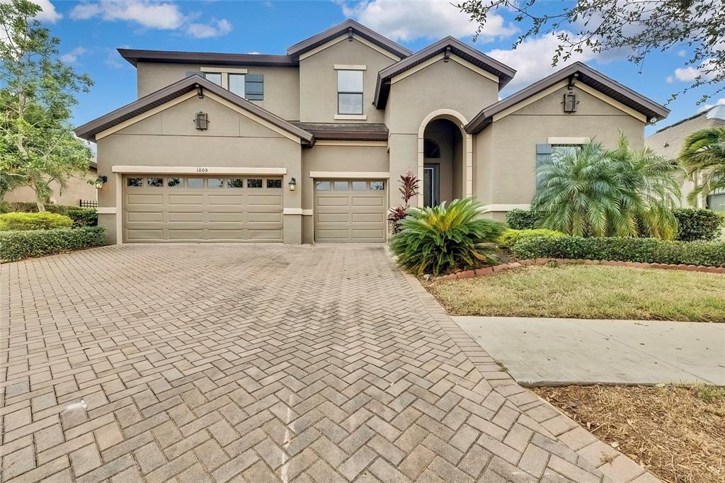 a front view of a house with a yard and garage