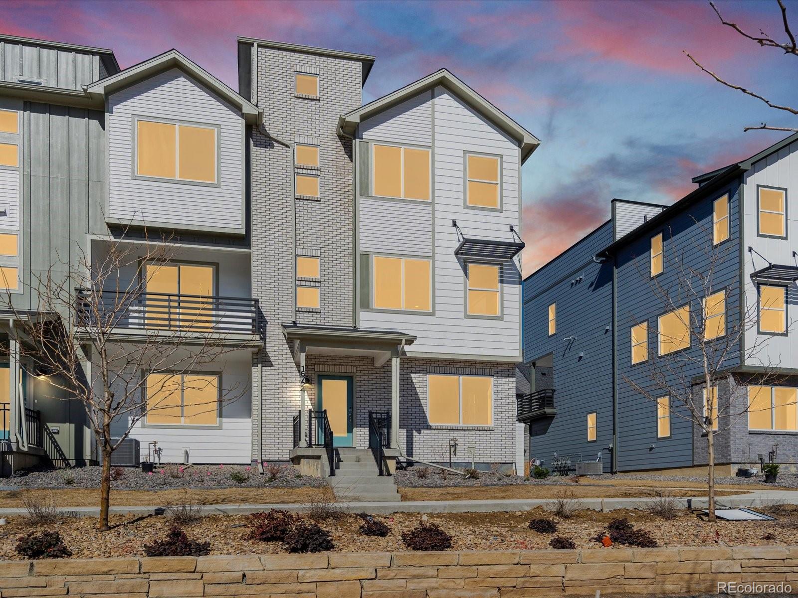 a front view of a residential apartment building with a yard