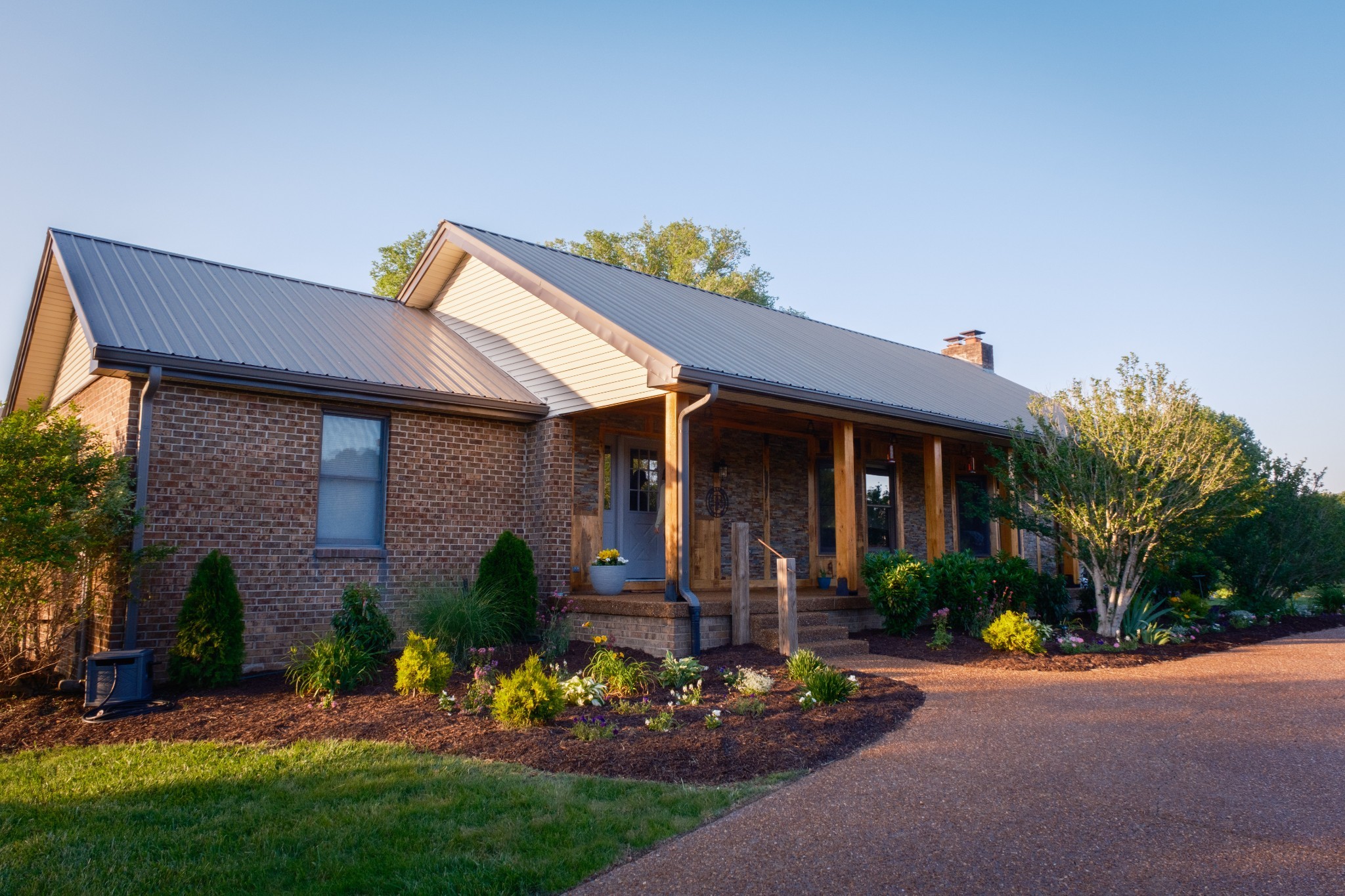 a front view of a house with a yard and outdoor seating