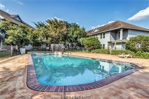 a view of a swimming pool with a patio