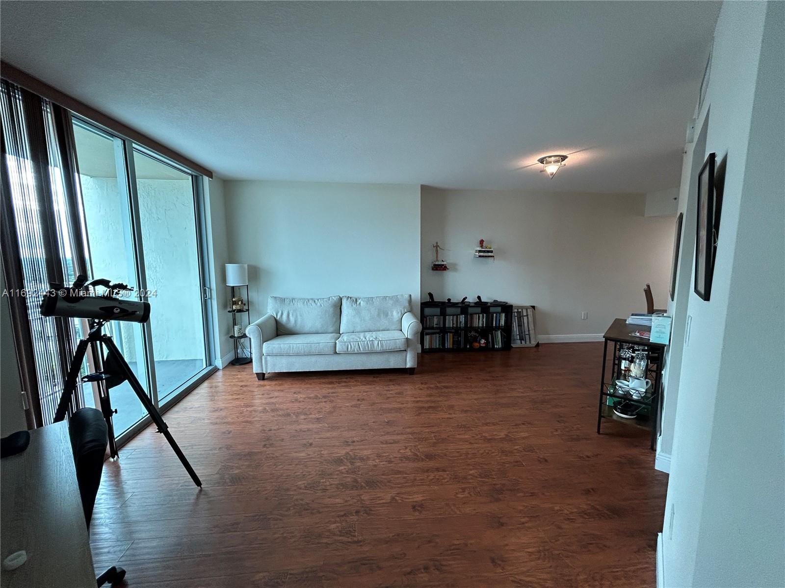 a living room with furniture and a mirror