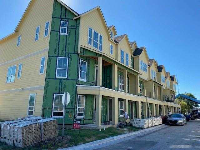 a front view of a residential apartment building with a yard