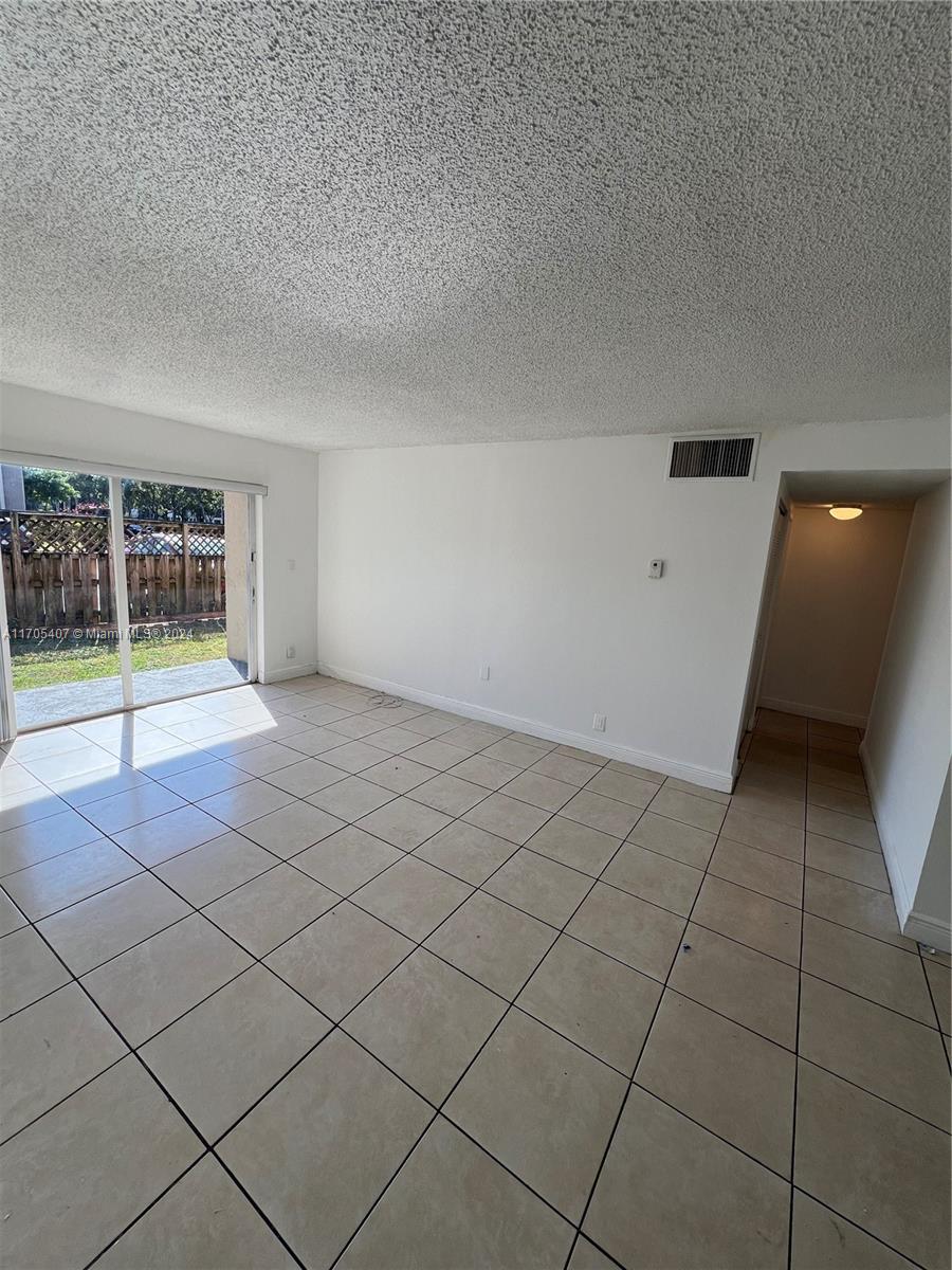 a view of an empty room and a window