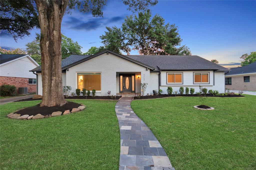 a front view of a house with a garden and porch