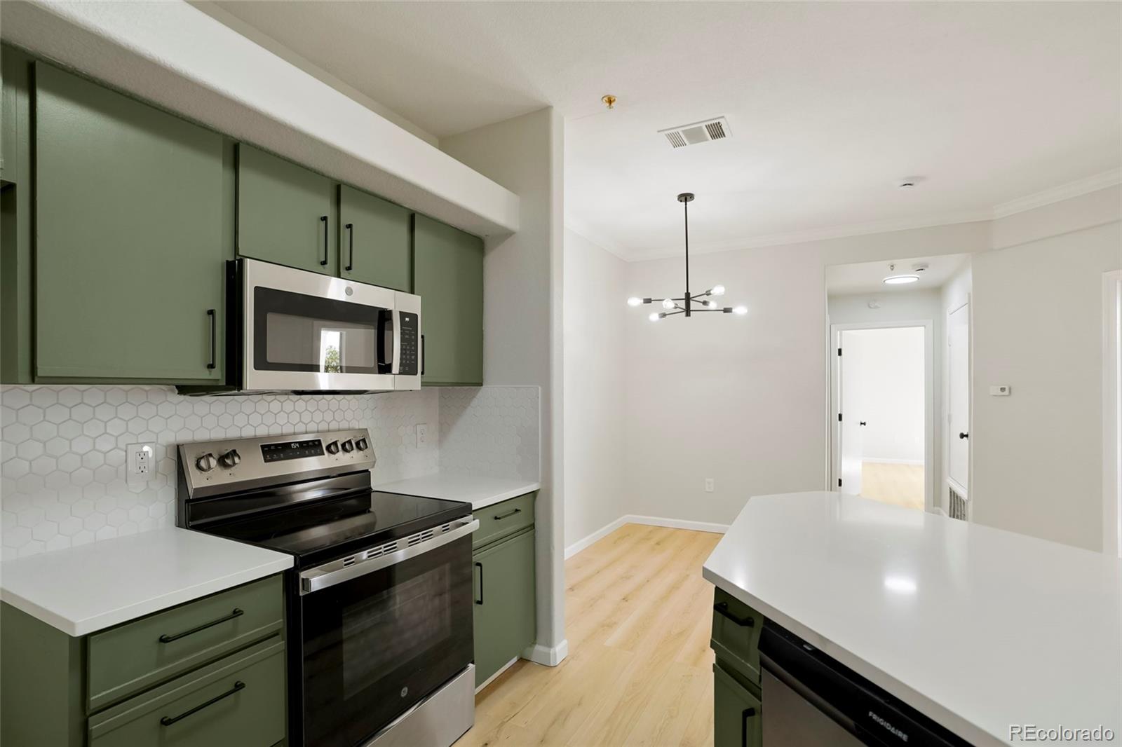 a kitchen with a sink stove and microwave