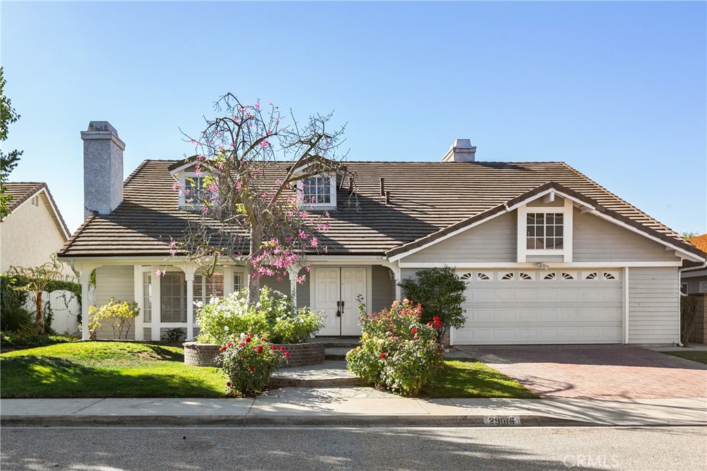 a front view of a house with a garden and plants