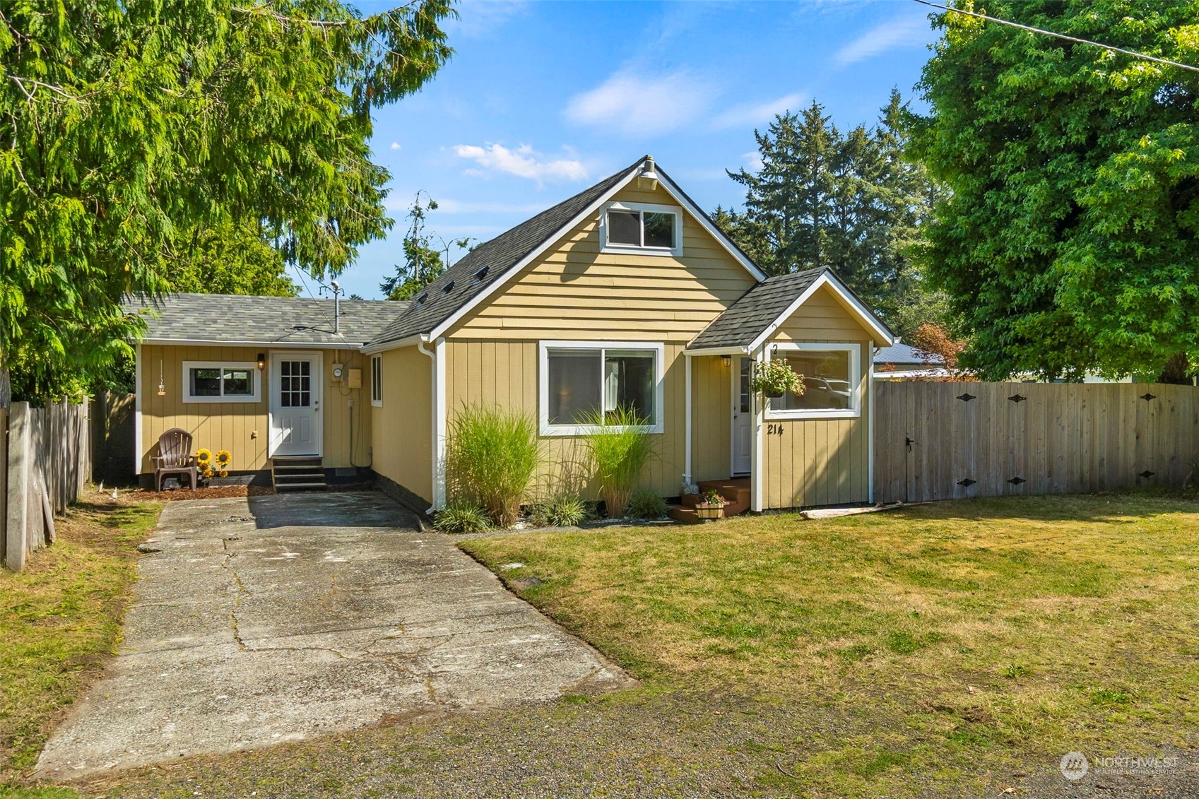 a front view of a house with a yard outdoor seating and garage