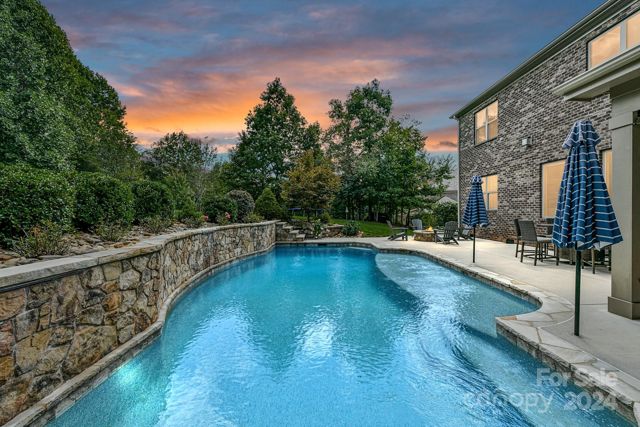 a view of a swimming pool with an outdoor seating