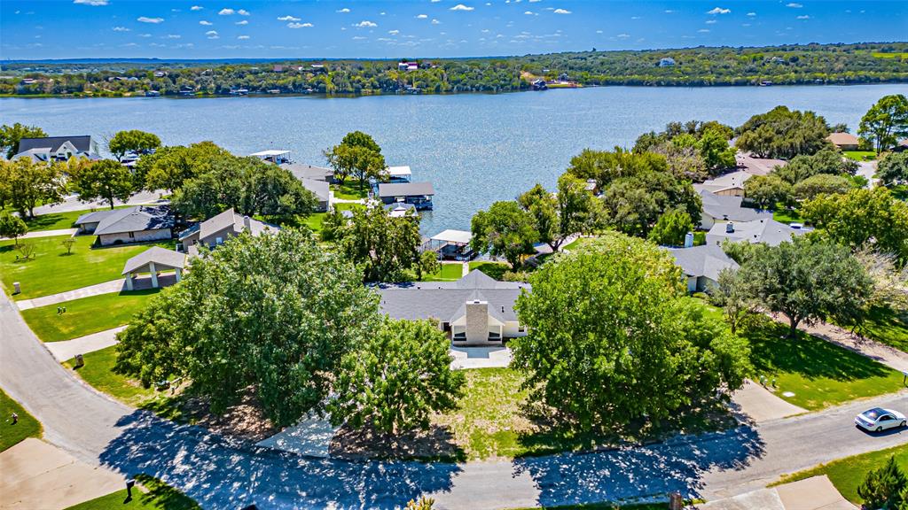 an aerial view of a houses with a lake view