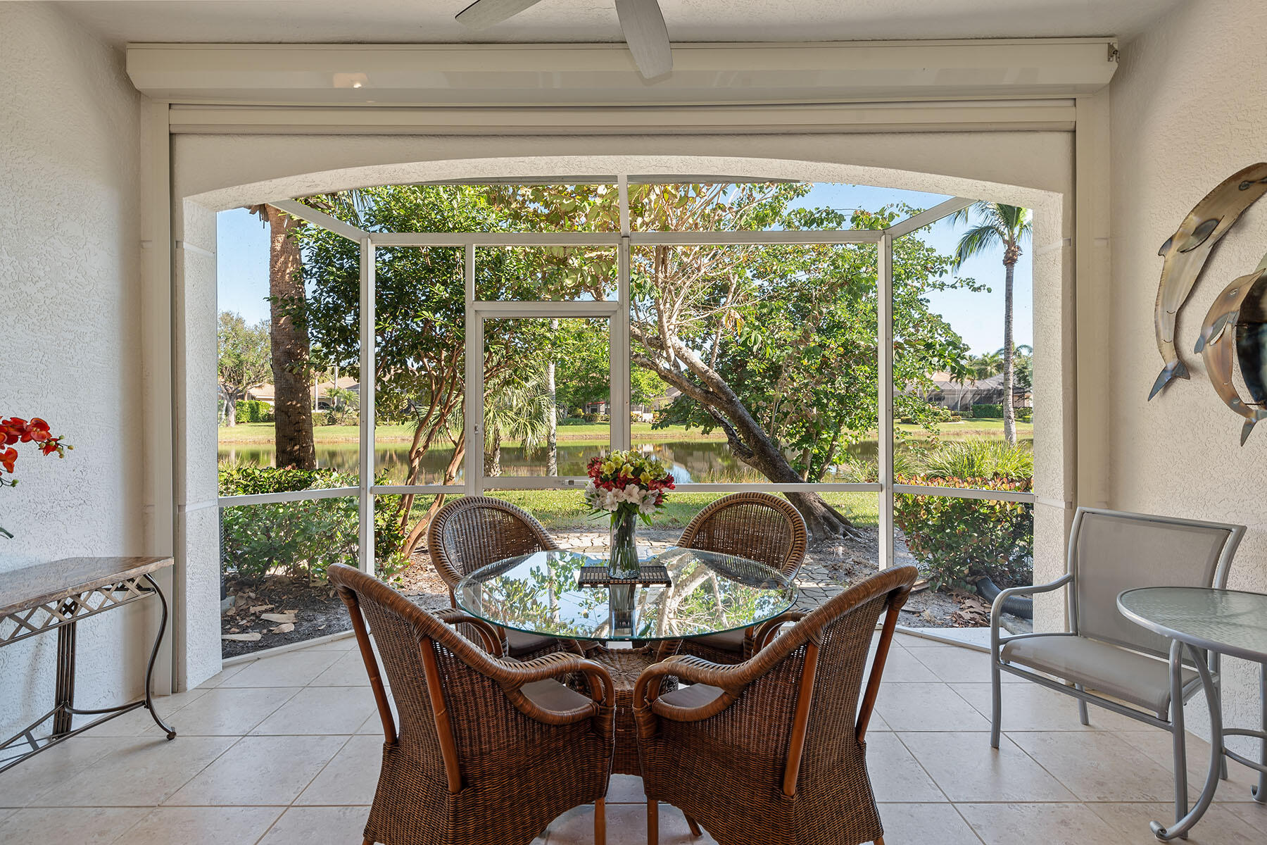 a dining room with furniture and a floor to ceiling window