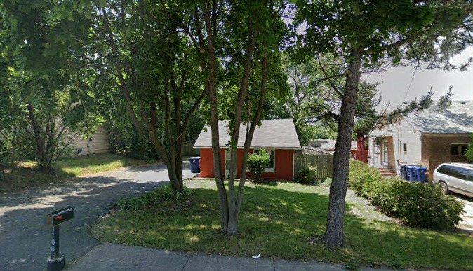 a view of a house with backyard and a tree