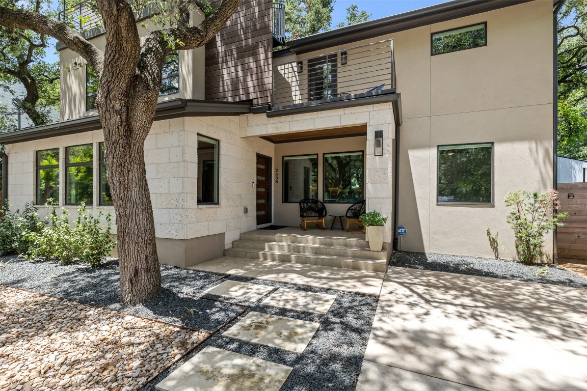 a view of a house with a tree in front