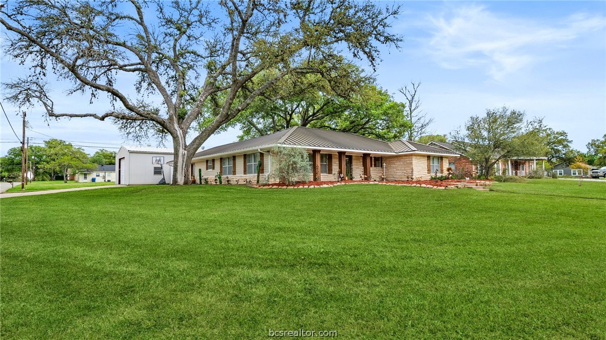 a front view of house with yard and green space