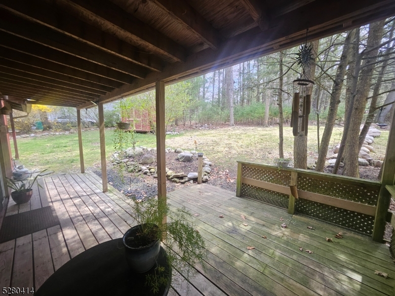 a view of a porch with furniture and wooden floor