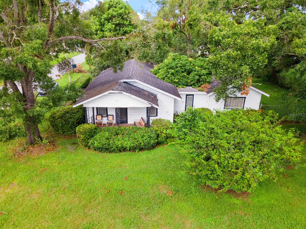 a aerial view of a house next to a yard