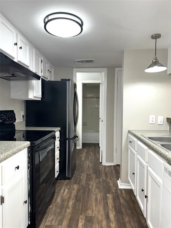 a kitchen with a refrigerator and a stove