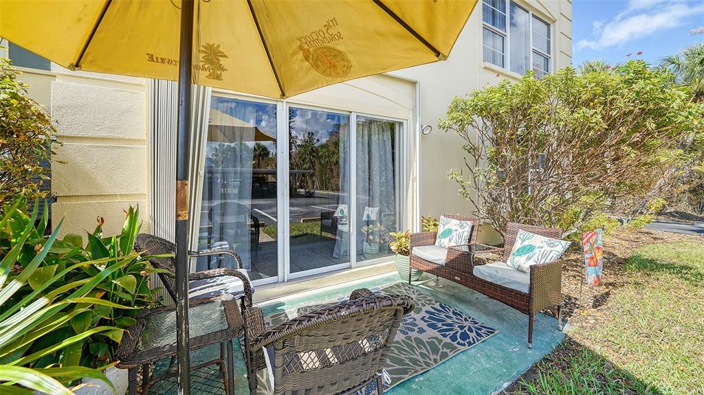 a view of a patio with table and chairs and potted plants