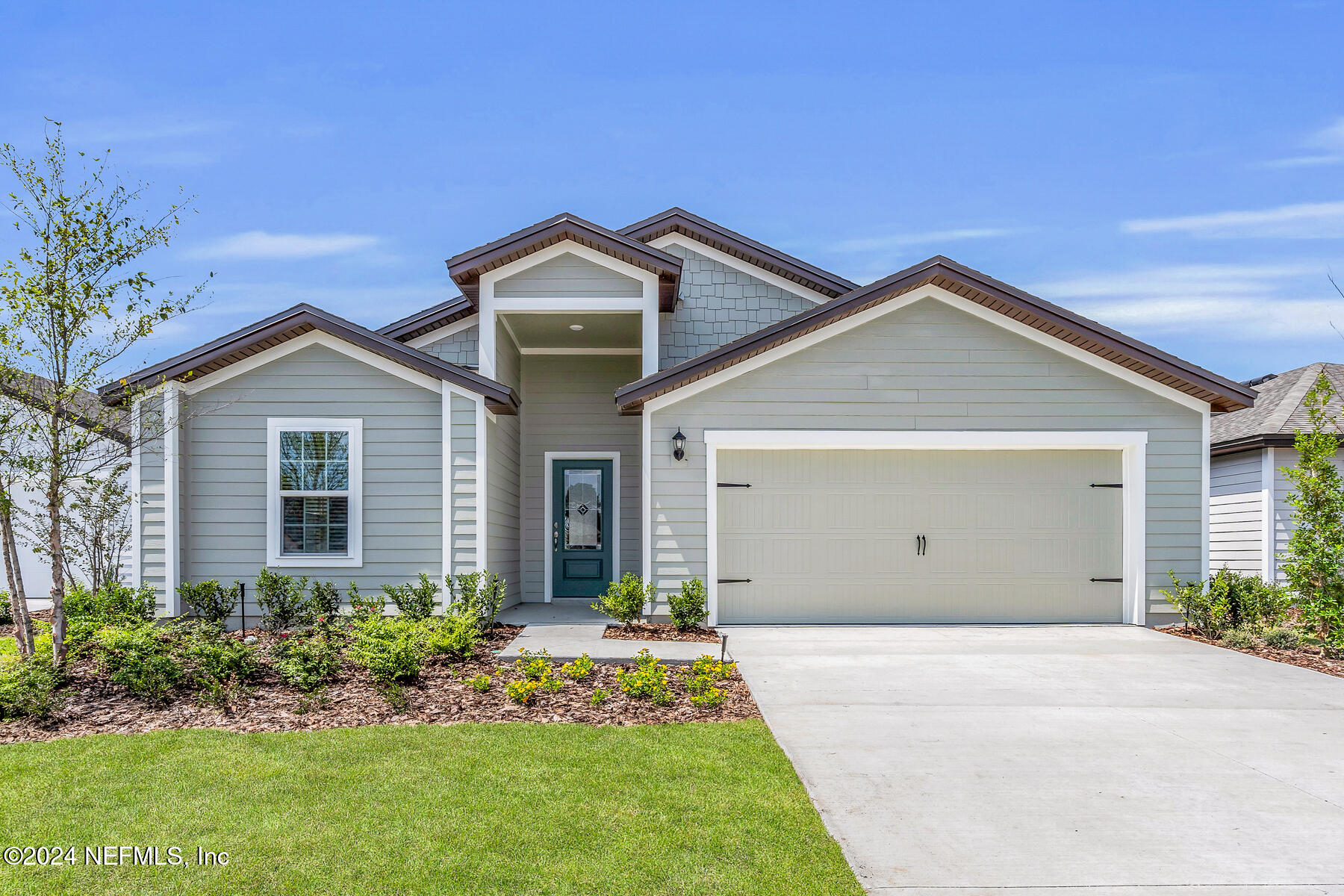 a front view of house with yard and green space