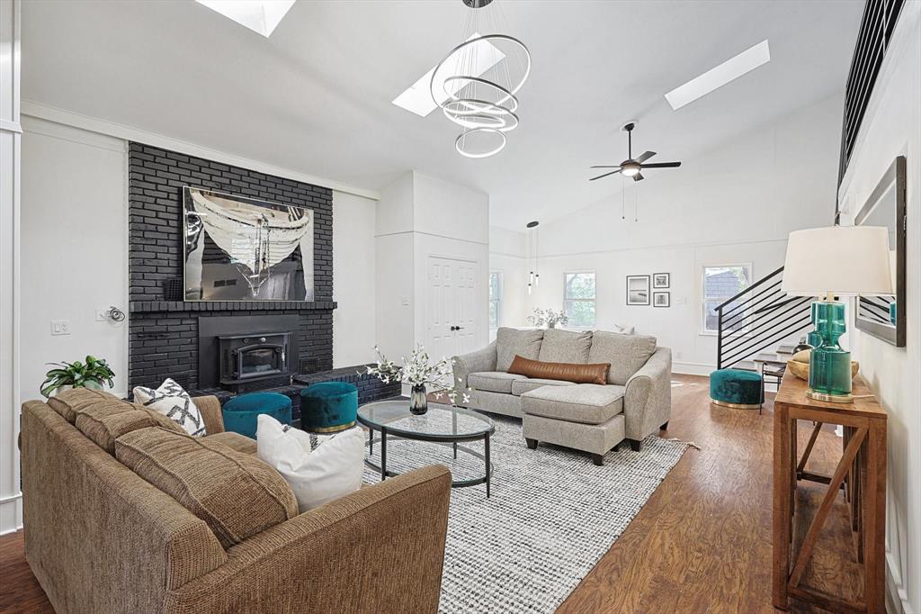 a living room with furniture a fireplace and paintings on the wall