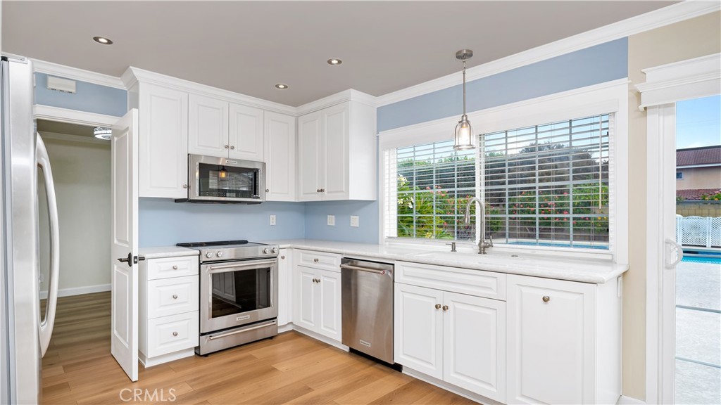 a kitchen with white cabinets and white appliances