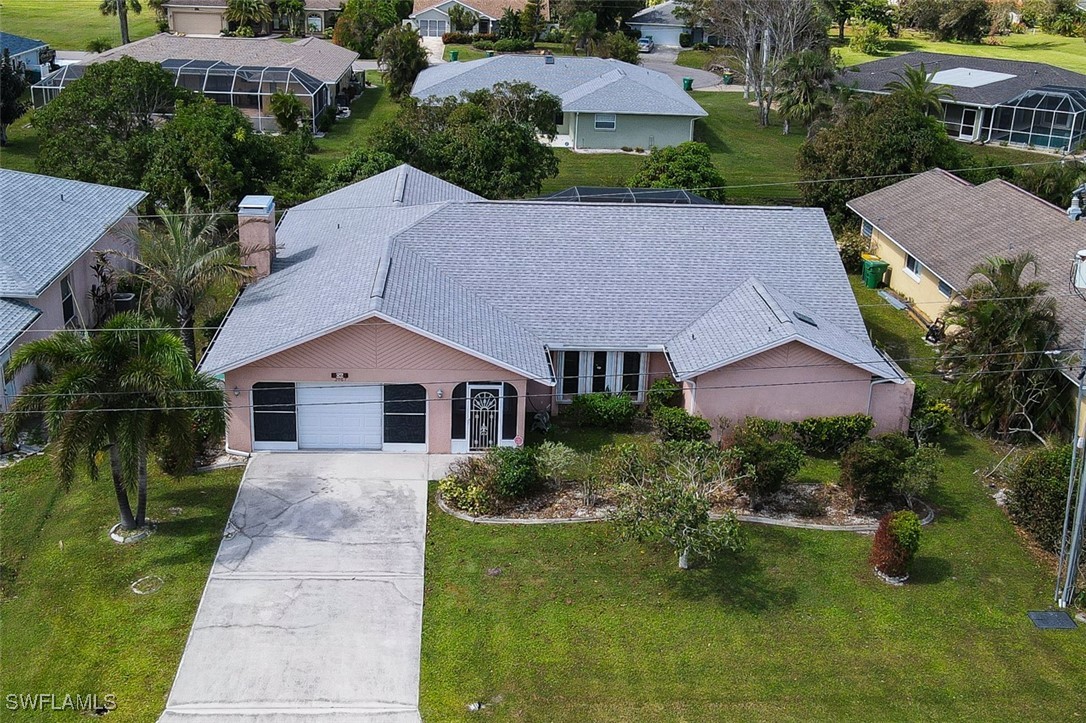 an aerial view of house with yard and trees