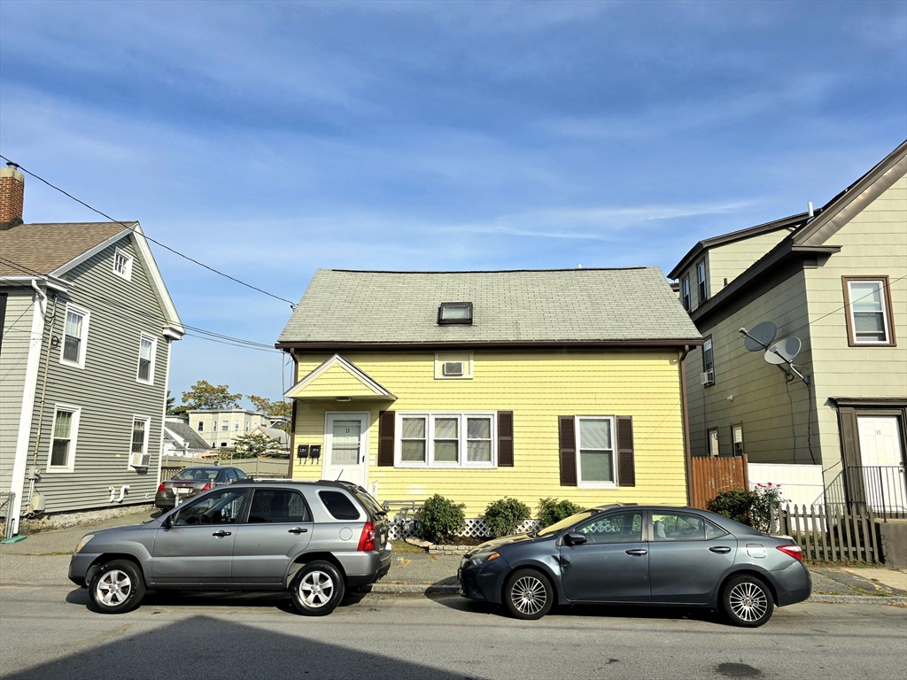 a view of a cars park in front of a house