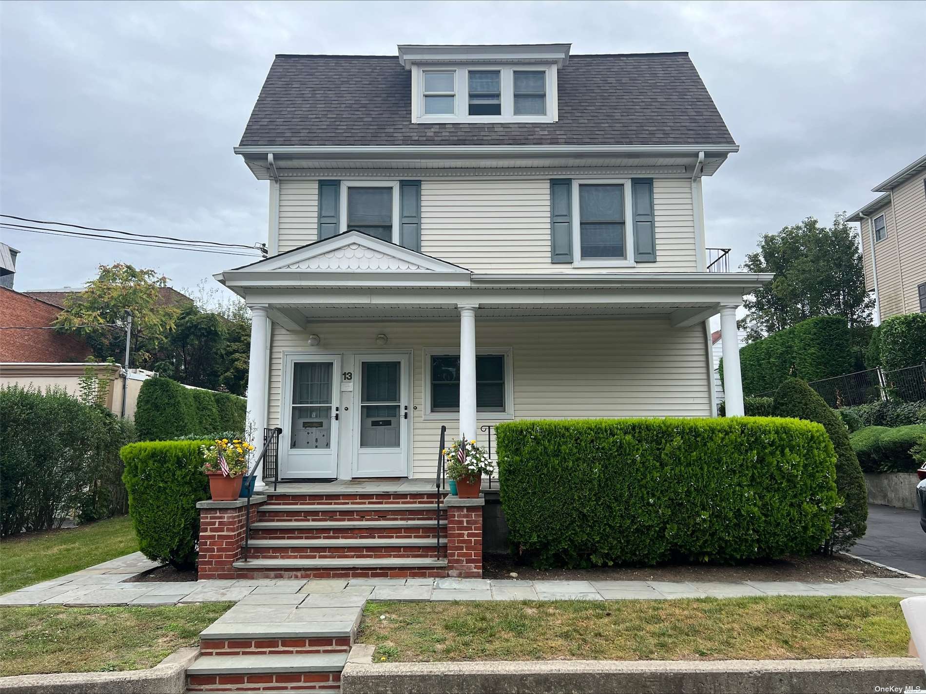 a front view of a house with a garden