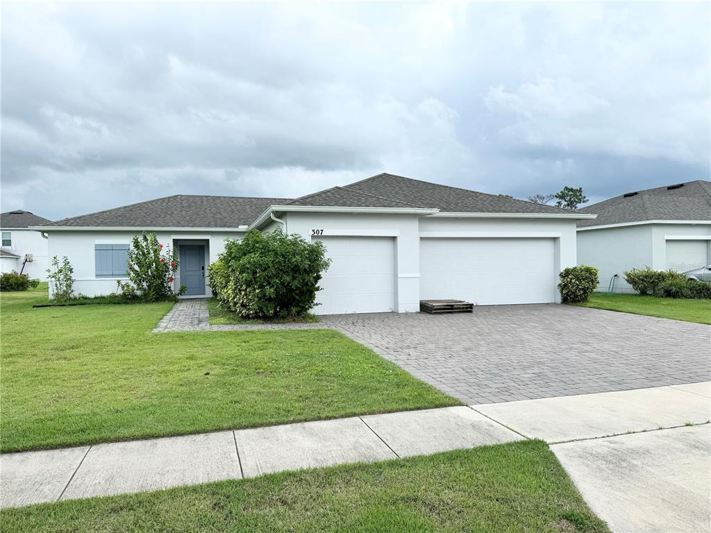 a front view of a house with a yard and garage