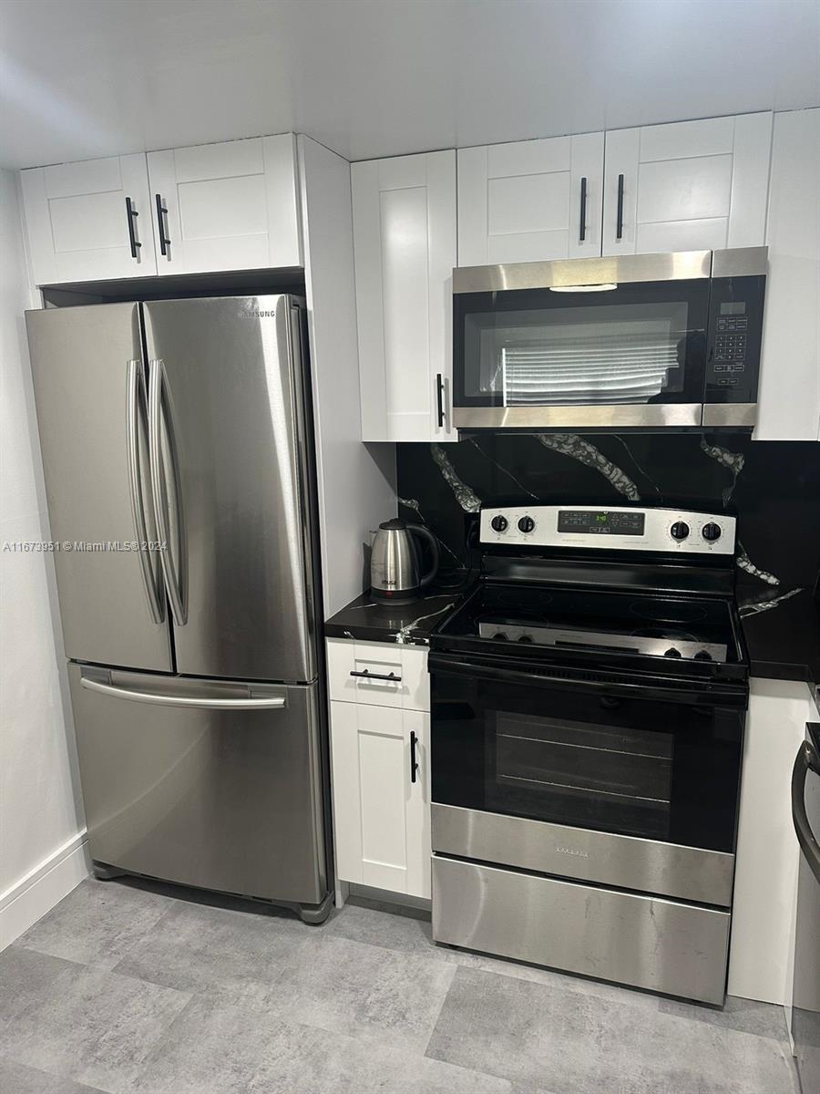 a stove top oven sitting inside of a kitchen