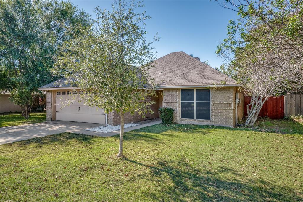 a view of a house with a yard and tree