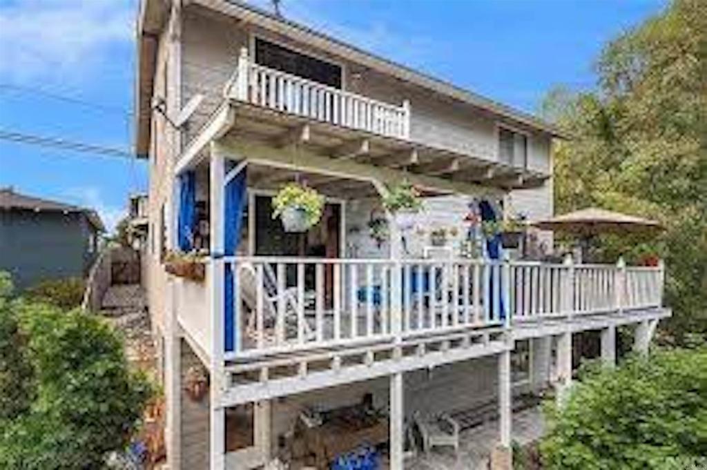 a view of a house with a small deck