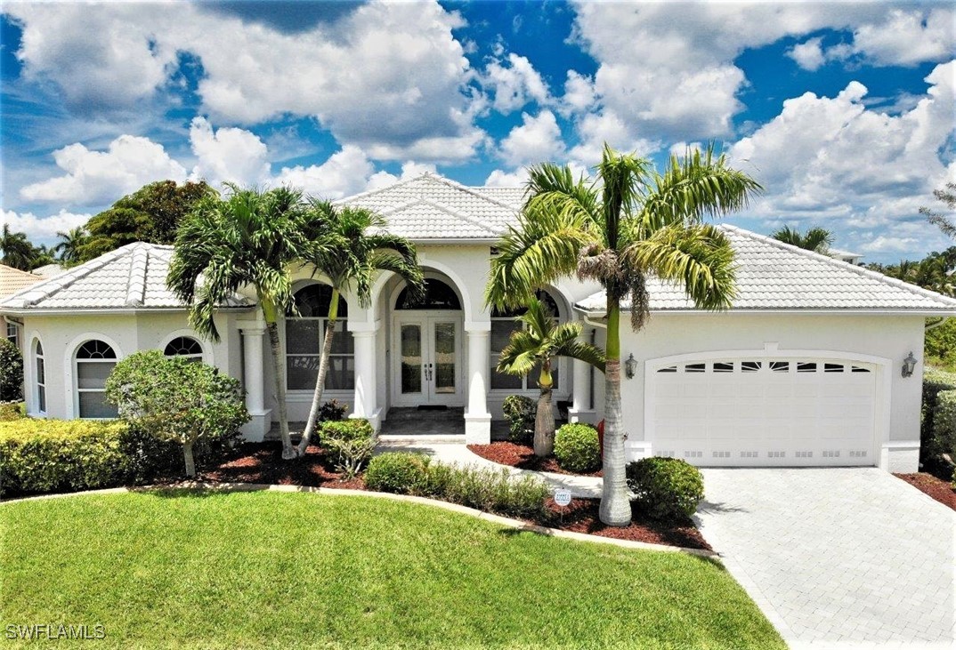 a front view of a house with a garden