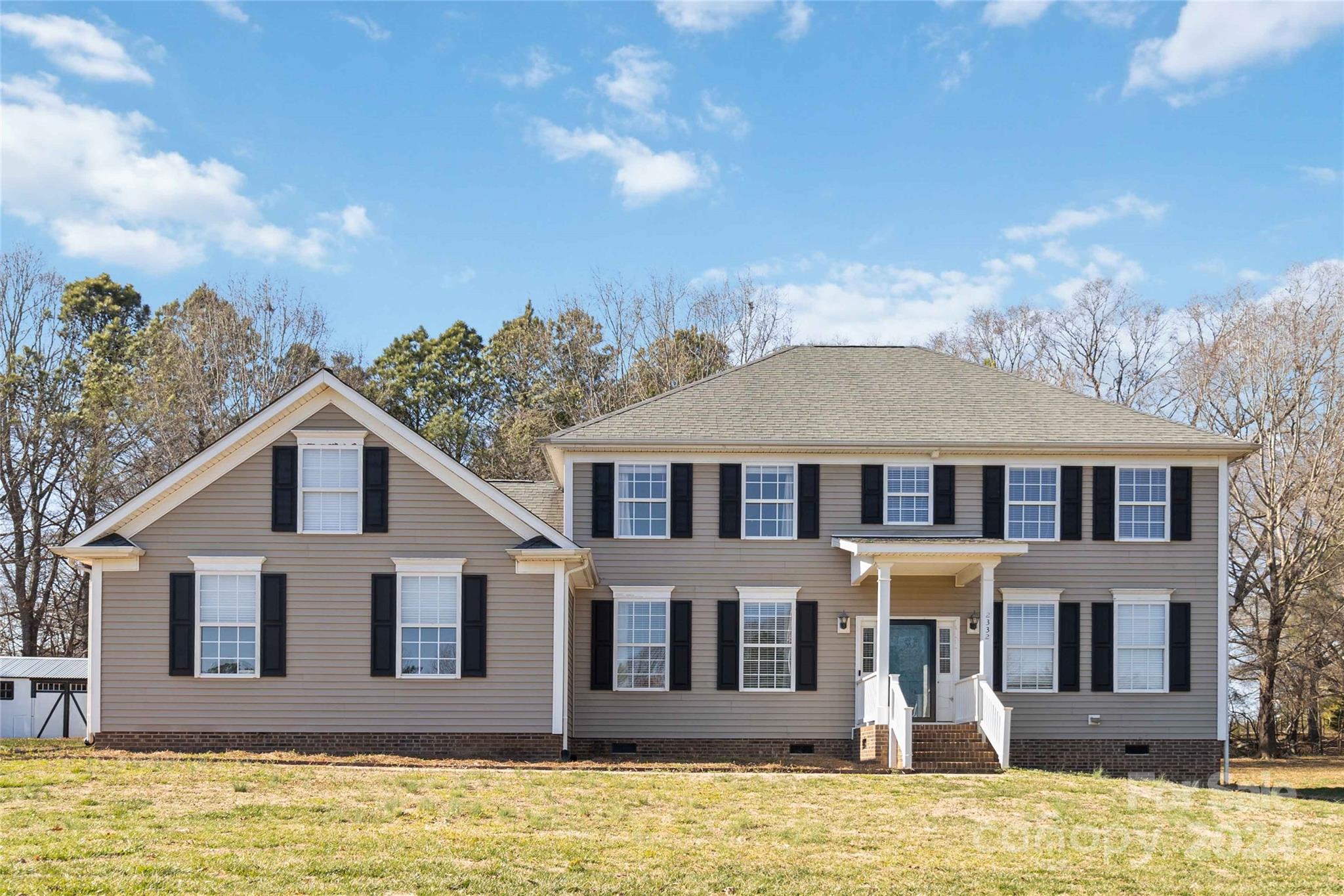 a front view of a house with a yard