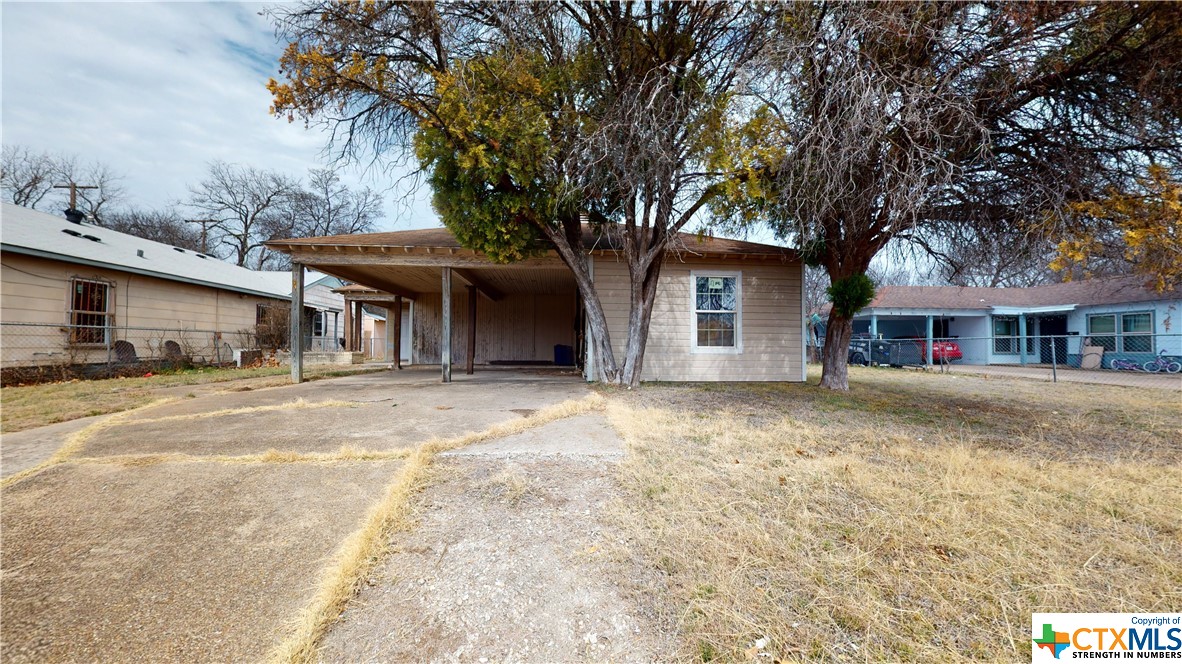 a front view of a house with a trees