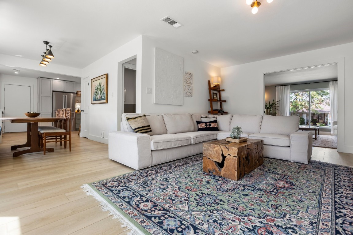 a living room with furniture and wooden floor