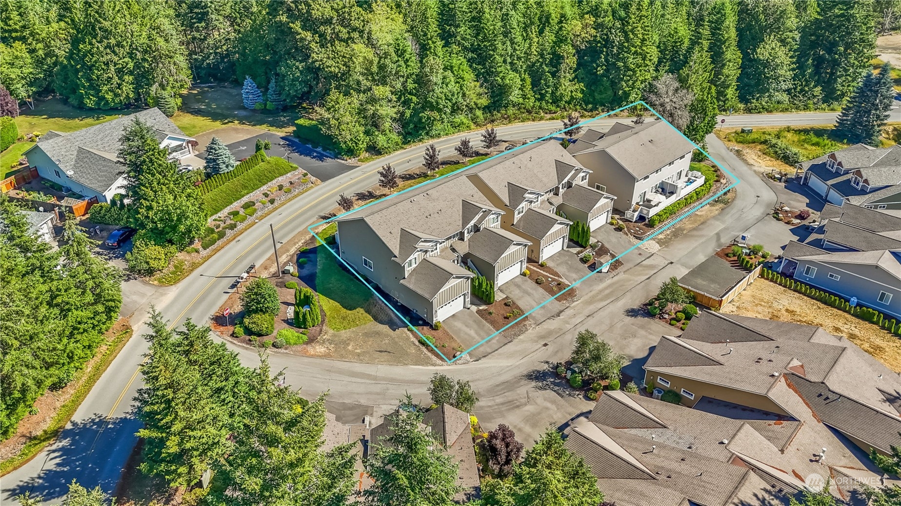 an aerial view of a house with a yard