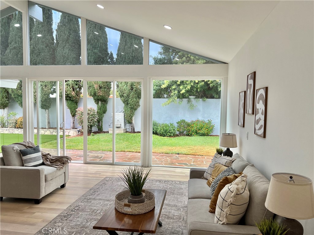 a living room with furniture and a floor to ceiling window