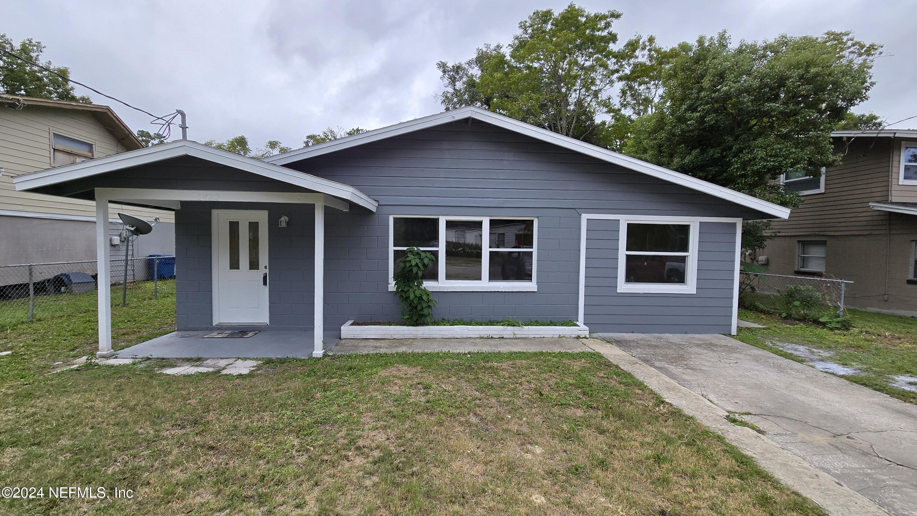 a front view of house with yard and green space